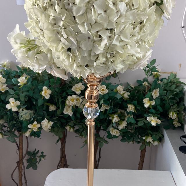 White floral ball centrepiece on a gold stand